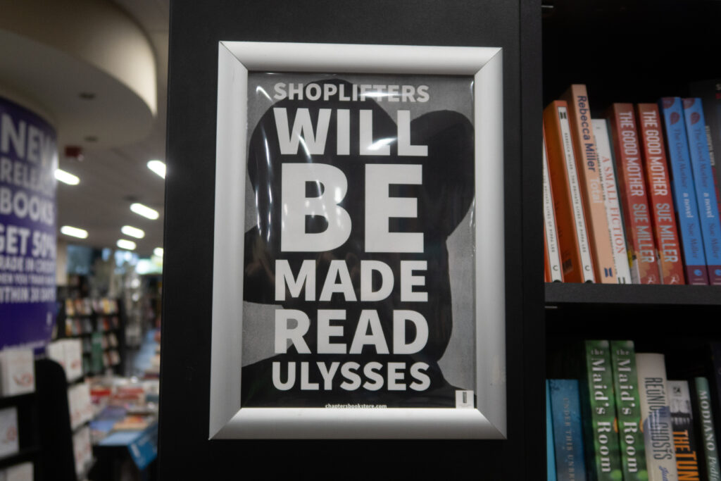 A bookshop sign that says Shoplifters will be made to read Ulysses