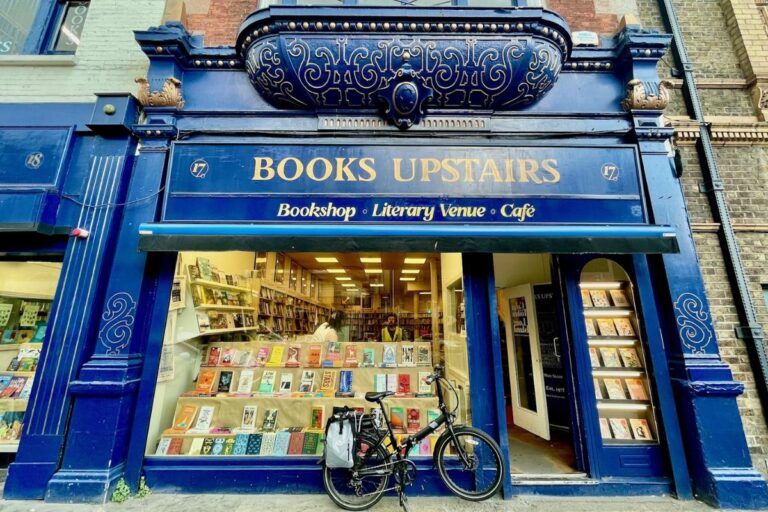 Front window with blue frame of Books Upstairs Bookstore in Dublin with their upstairs cafe and famous bay window